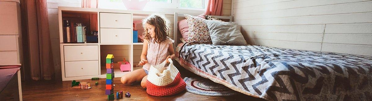 Niña jugando con casas de juguete