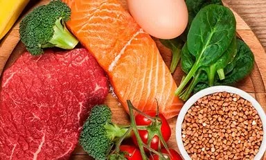 Mesa con alimentos variados: frutas, verduras, lácteos, carnes, granos y frutos secos para una dieta nutritiva